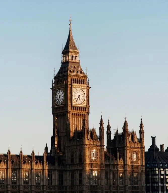 Vue détaillée de la tour Elizabeth abritant Big Ben au Palais de Westminster à Londres, baignée par la lumière dorée du soleil couchant, pour illustrer les services de livraison de Landmark Global vers le Royaume-Uni